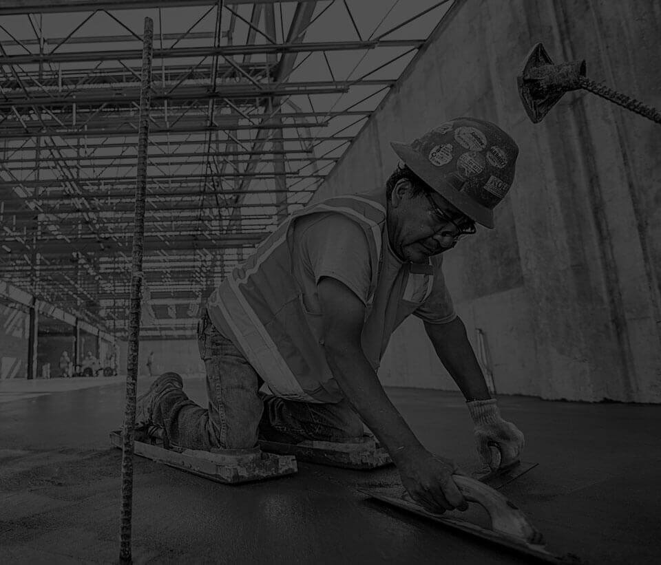 Photo of one Kolde employee smoothing concrete